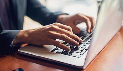 Close up of a hands of a businessman on a keyboard.